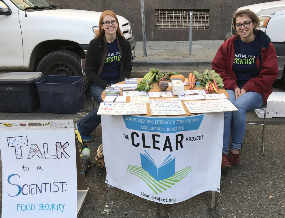 student scientists at a table at the berkeley farmer's market