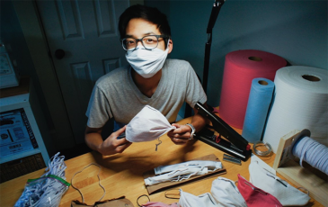Christopher Gee making masks at a desk